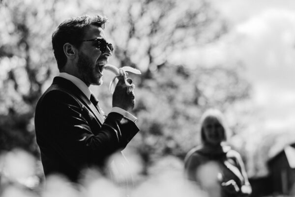 man-eating-banana-at-wedding